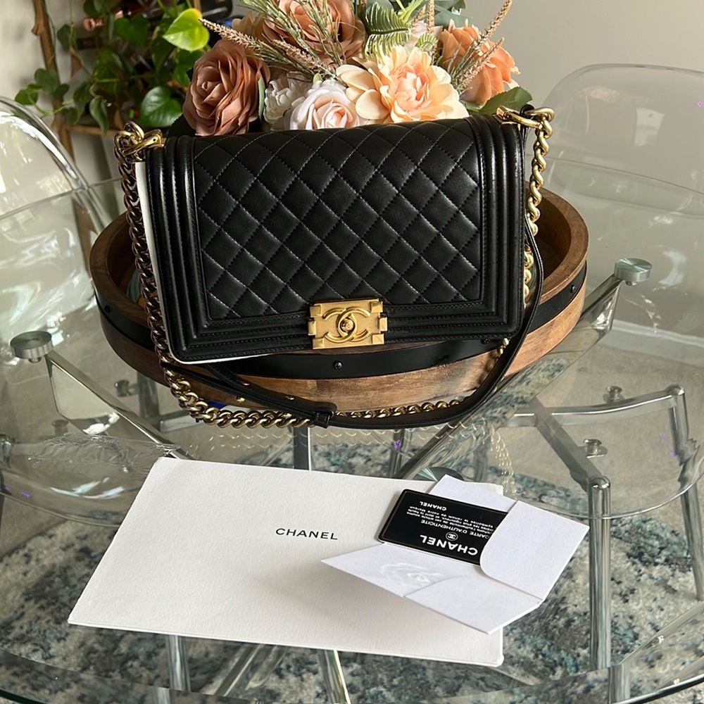 Authentic black Chanel medium gold chain bag. Normal scratch and wear.